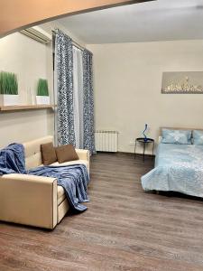 明斯克Apartment near Zybitskaya的客厅配有沙发和1张床