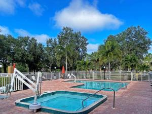 萨拉索塔Comfort Inn & Suites Sarasota I75的一座带金属围栏的公园内的游泳池