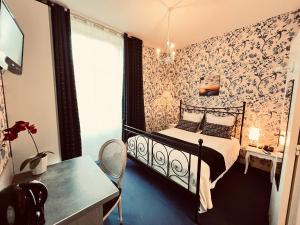 瑟瑞奥克斯布瓦奇卡莫尔城堡酒店的一间卧室配有一张床、一张桌子和一个窗户。