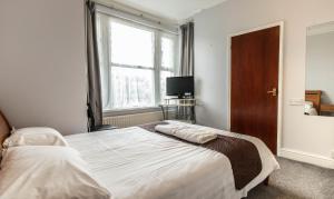 剑桥谢尔福德住宿加早餐旅馆的一间卧室设有一张大床和一个窗户。