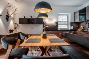 上特劳恩Bergmoment Apartments的一间带木桌和椅子的用餐室