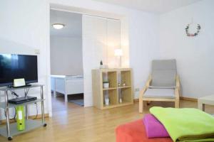 FreirachdorfDEB 035 Ferienwohnung im Westerwald的一间带电视和椅子的客厅