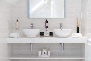 巴利利芬Ballyliffin TownHouse Boutique Hotel的白色的浴室设有两个盥洗盆和镜子