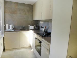 圣莫里茨Apartment Chesa La Soliva by Interhome的厨房配有白色橱柜和水槽