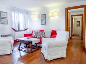 圣莫里茨Apartment Chesa Sonnalpine B 52 by Interhome的客厅配有红色沙发和白色椅子