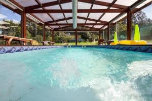 BamaCasa Compostela的一个带木制凉亭的大型游泳池