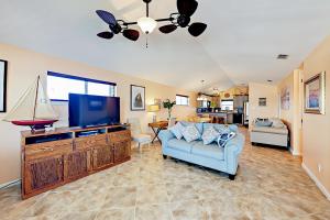 阿兰瑟斯港Sunflower Hello的客厅配有蓝色的沙发和平面电视。