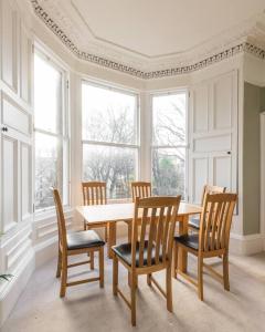 爱丁堡Stunning 3 Bedroom Flat in Bruntsfield的一间带桌椅和窗户的用餐室