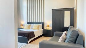 波尔图Gardenia Aparthôtel的配有一张床和一把椅子的酒店客房