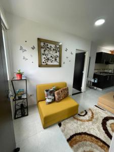 圣希尔Apartaestudio San Gil - Hostal Green的客厅配有黄色沙发和地毯。