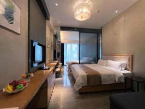 广州广州威珀斯酒店的酒店客房,配有床和电视