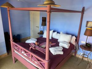 贝纳卢普-卡萨斯维耶哈斯Charming 2 bedroom villa on Fairplay Golf course的一间卧室配有一张四柱床和天蓬