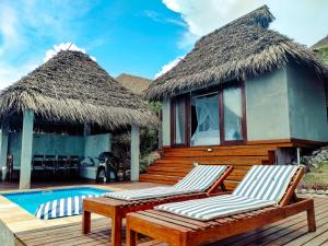 伊尼扬巴内The Beach House的一个带游泳池和两张躺椅的度假胜地