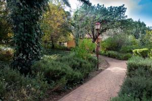 ParodMantur Parod by Selina的花园中一条带轻 ⁇ 的砖路