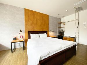 台中市台中欧菲旅店的一间卧室配有一张大床和木制床头板