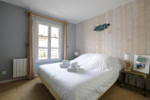 圣马丹德雷Sur l'ilot, au centre du port, vue UNIQUE !的卧室配有白色的床和窗户。