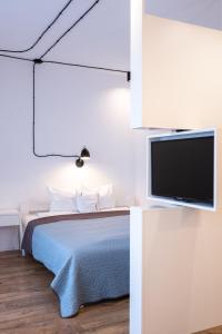 什切青Check in Szczecin的一间卧室配有一张床和一台平面电视