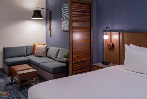 坦帕Hyatt Place Tampa Downtown的酒店客房,配有床和沙发