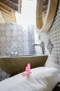 吉利特拉旺安Java Wood的浴室桌子上方的粉红色带状带