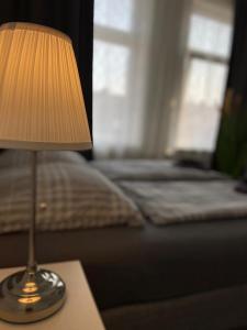 不来梅港不来梅港城市膳食公寓酒店的床头桌旁的灯