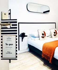 勒图凯-巴黎普拉日Hôtel Gaspard的一间卧室配有一张无pas障碍标志的床