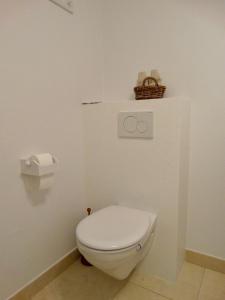 伊特博尔德BENVENUTI的浴室内的白色卫生间,墙上有篮子