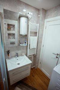 新瓦罗什Apartman Vesna的浴室设有白色水槽和镜子