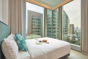 新加坡Citadines Raffles Place Singapore的酒店客房设有一张床和一个大窗户