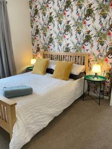 布里斯托Maple House的一间卧室配有一张带花卉壁纸的大床