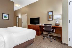 悉尼Comfort Inn & Suites Sidney I-80的酒店客房配有一张床和一张带电脑的书桌