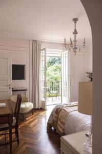 波托菲诺Splendido, A Belmond Hotel, Portofino的一间卧室配有一张床、一张桌子和一张桌子