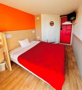 特拉普圣昆廷伊夫林伊兰科特普瑞米尔经典酒店的一间卧室配有一张带红色毯子的大床