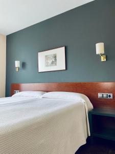 艾丝黛拉耶尔丽酒店的一间卧室设有两张床和蓝色的墙壁