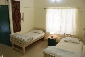 Bhitey Homestay SIMANTAPALLY / SHANTINIKETAN客房内的一张或多张床位