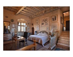 Senouillacchâteau de Mauriac的一间卧室配有一张床、一张桌子和楼梯