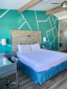 圣巴巴拉东海滩酒店的一间卧室配有一张大床和一张书桌