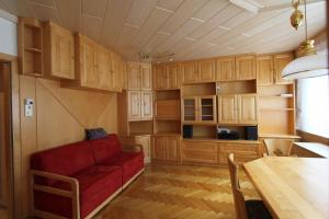 格拉茨Vintage Apartment的客厅配有红色沙发和木柜