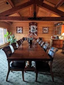 桑德波因特桑德珀恩特小屋酒店的一间会议室,配有一张大木桌子和椅子