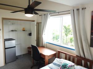 希洛夏威夷奥纳之家住宿加早餐旅馆的一间卧室设有书桌和窗户。