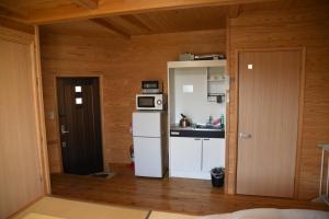 南阿苏村瓦卡旅馆的小厨房配有冰箱和微波炉。