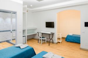 卡塔尼亚乐度纳西西里酒店的酒店客房配有两张床和一张书桌