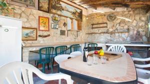 蒙特巴巴特2Alo - Lloret de Mar的厨房配有一张桌子和椅子,厨房设有石墙