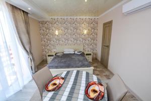 格里比夫卡Парк-отель Коттеджи Меркурий的卧室配有一张床和一张桌子及椅子