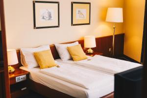 克尼特尔费尔德Paul's Hotel的酒店客房设有两张床和两盏灯。