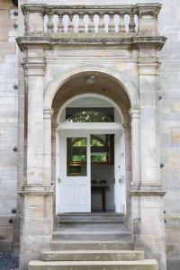 邓弗姆林巴尔穆勒之家酒店的白色门的建筑物入口