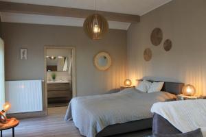 马尔梅迪La Veraison的一间卧室配有一张床、两盏灯和一面镜子