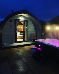 GalstonThistle Pod at Ayrshire Rural Retreats Farm Stay Hottub Sleeps 2的客房内的紫色浴缸