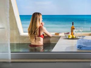 冯塔尼比安奇白色海湾酒店的坐在浴缸中的女士,享有海景
