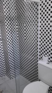 圣保罗Hotel Pousada Clínicas Jardins Paulista的浴室设有黑色和白色的瓷砖墙壁和卫生间。