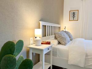桑帕克StayMenorca Redescubre la paz的一间卧室配有一张床和一张带仙人掌的桌子